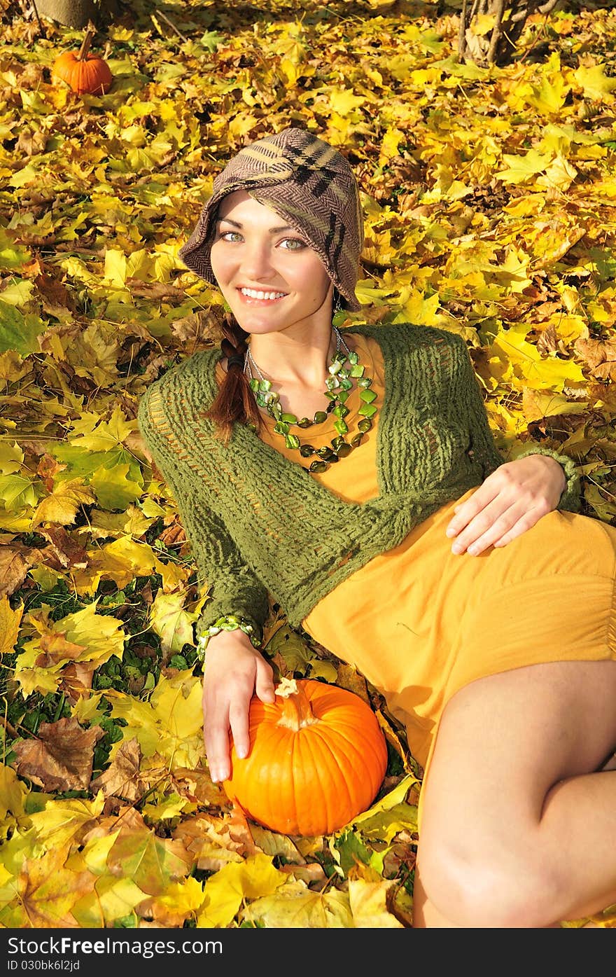 Cute young woman lying in yellow autum leaves. Cute young woman lying in yellow autum leaves