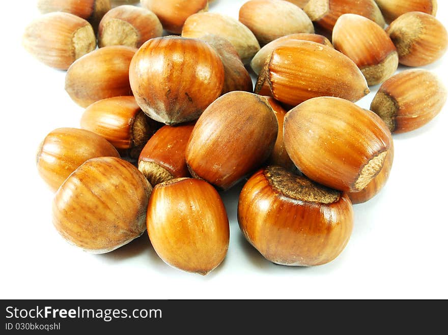 Brown hazelnuts isolated on white