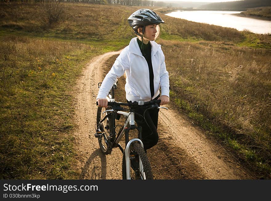 Girl relax biking in summer meadow. Girl relax biking in summer meadow