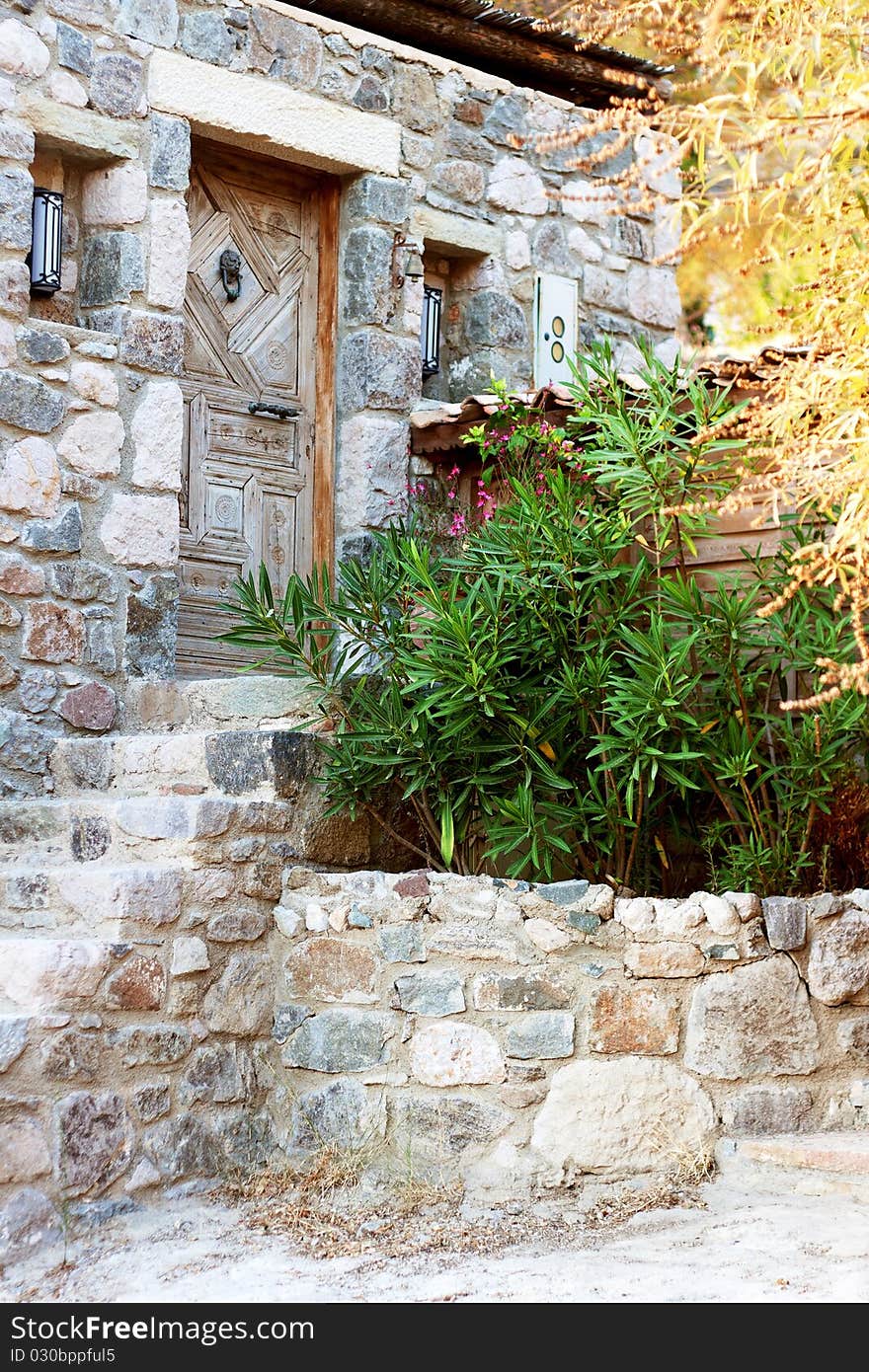 Old stone greek house entrance in a village