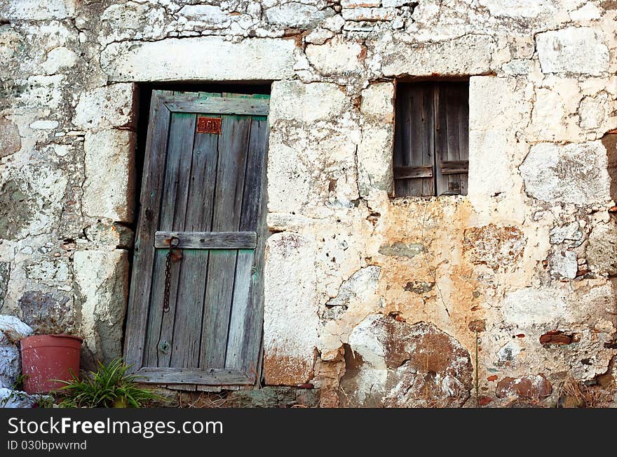 Old stone greek house entrance in a village