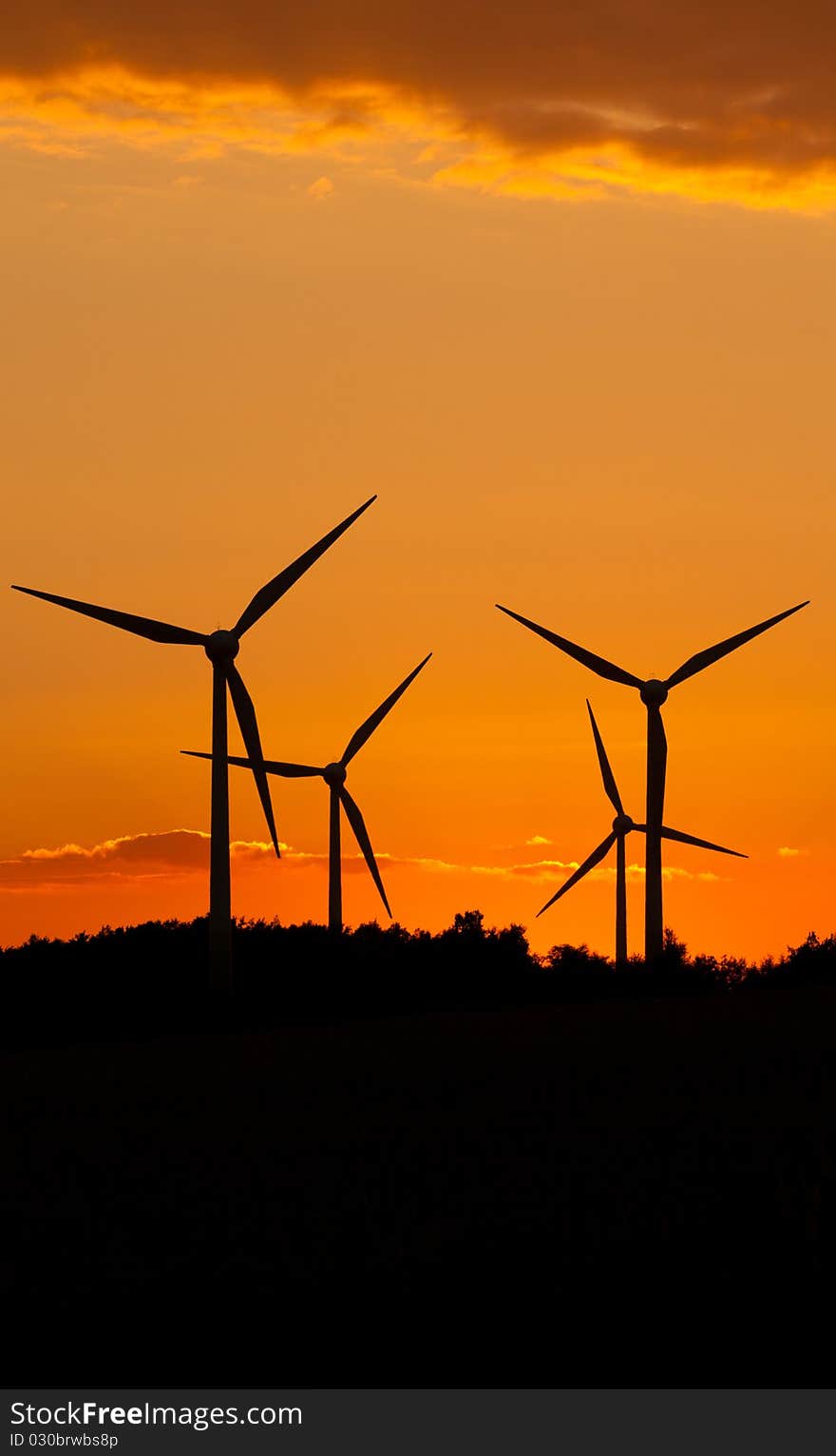 Windmill silhouette on suset background