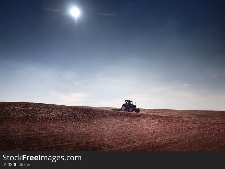 Tractor afield and blue sky