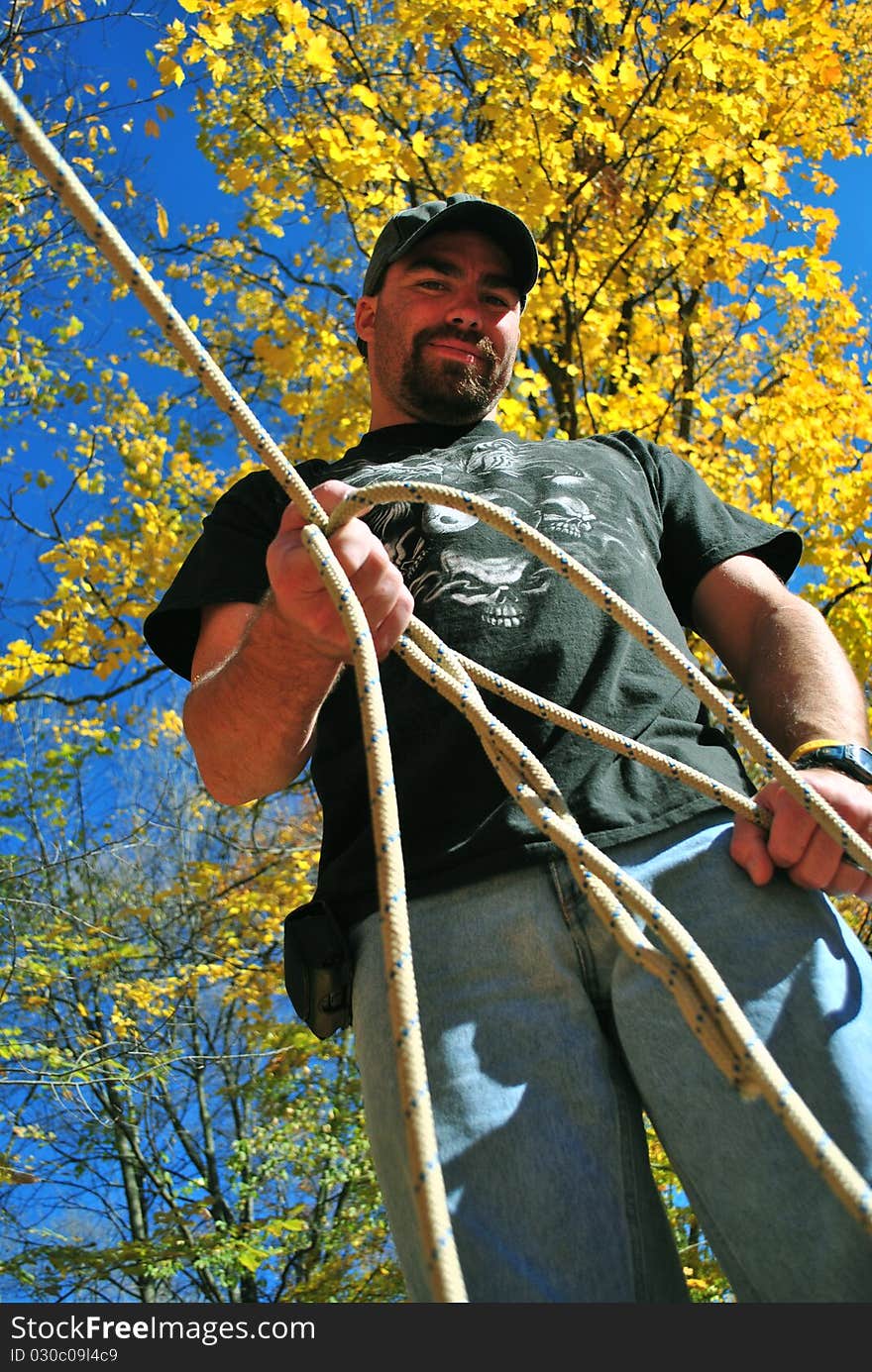 A man holding on to a length of rope. A man holding on to a length of rope.