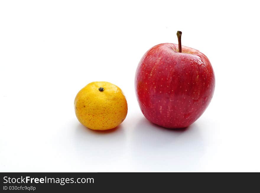 Tangerine and apple isolated on white