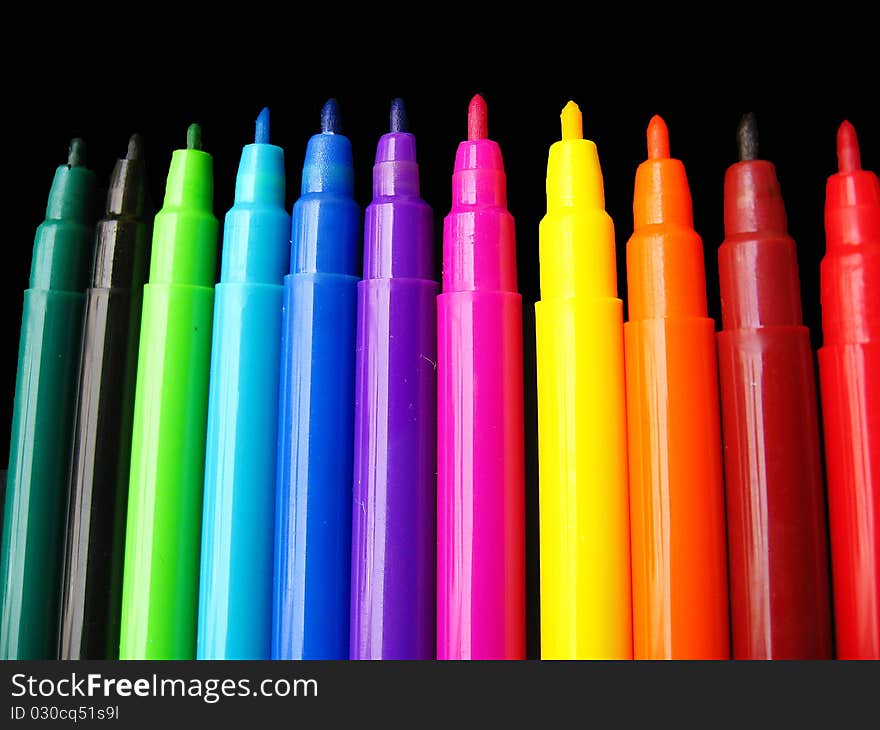 A background of plastic colorful sketch pens, used for drawing and sketching. A background of plastic colorful sketch pens, used for drawing and sketching.