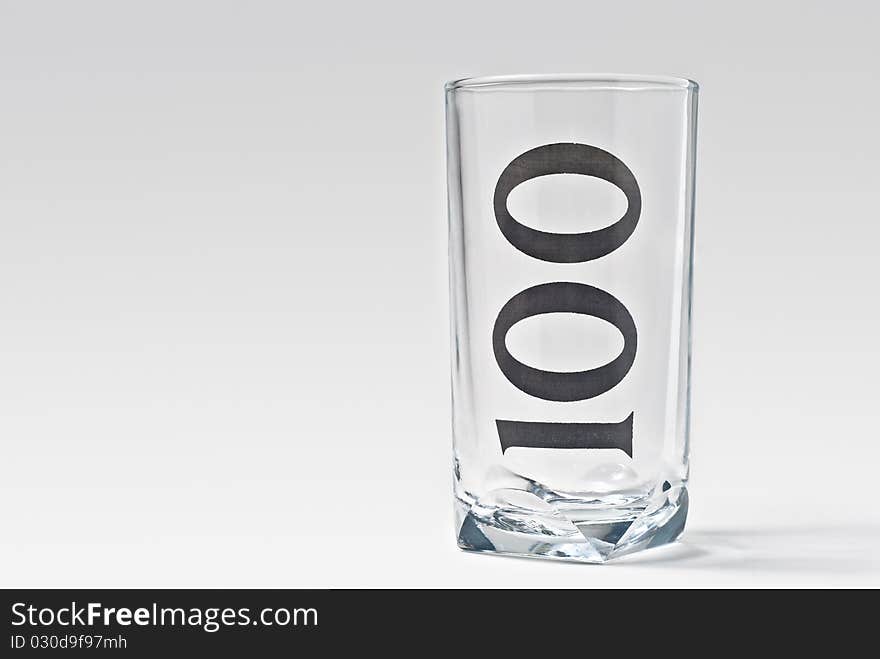 Isolated empty 100 glass with light shadow