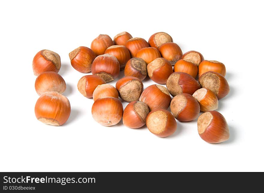 Pile of hazelnuts on a white background