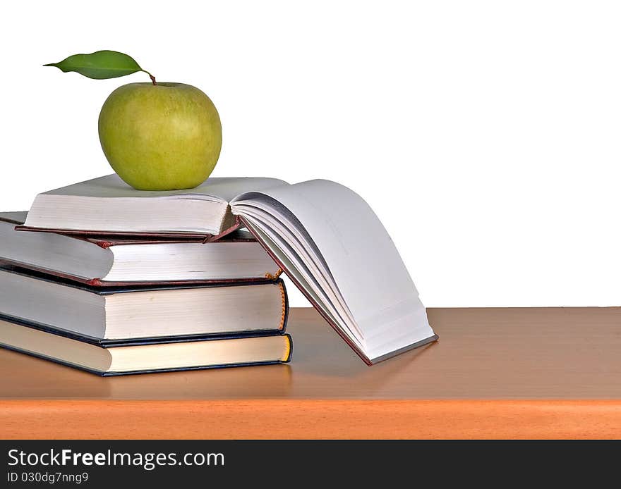 Green apple on books