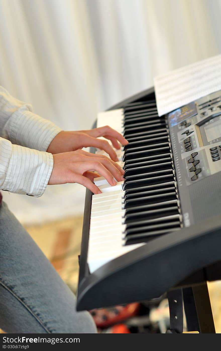 A woman's hands playing the Electronic piano. A woman's hands playing the Electronic piano