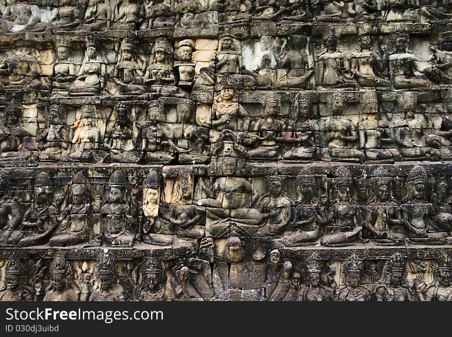 Huge detailed stone wall art carving of sitting figures, Angkor temples, Siem Reap, Cambodia. Huge detailed stone wall art carving of sitting figures, Angkor temples, Siem Reap, Cambodia