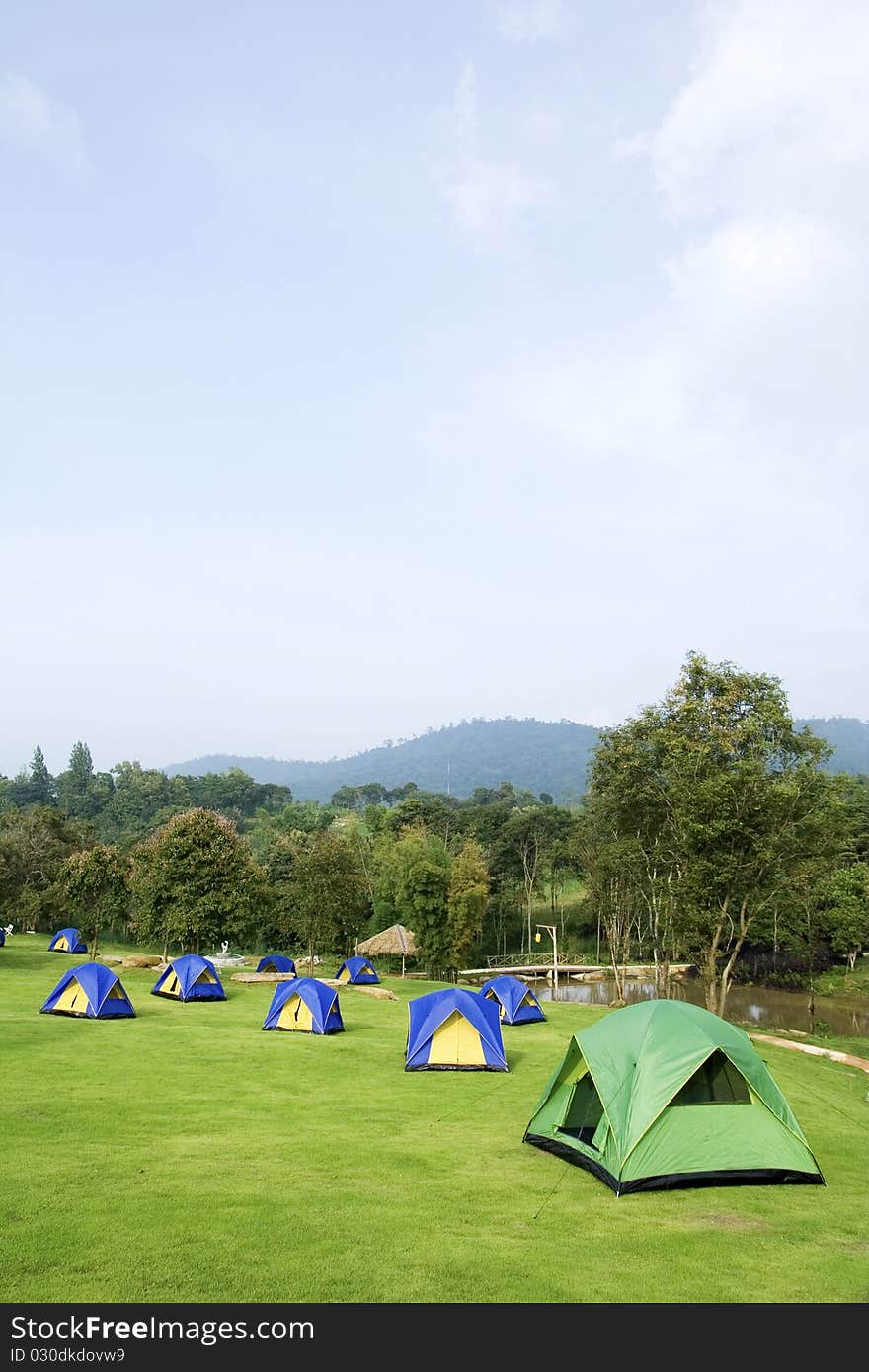 Many tents put on green grass. Many tents put on green grass