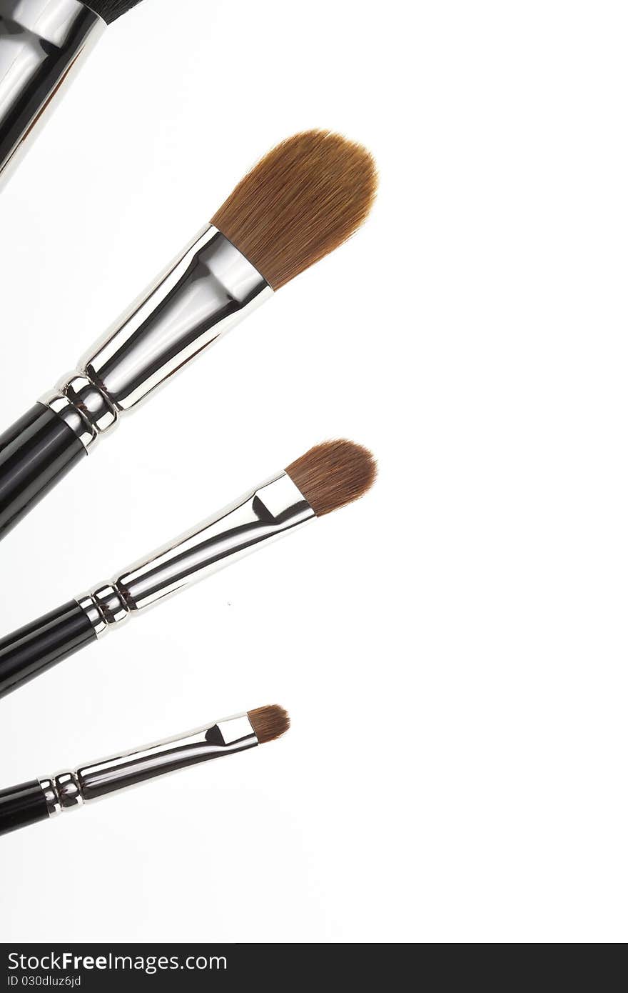 A detail of a 4 make-up brushes set, shot on white background. the brushes are set in a fan position. A detail of a 4 make-up brushes set, shot on white background. the brushes are set in a fan position.