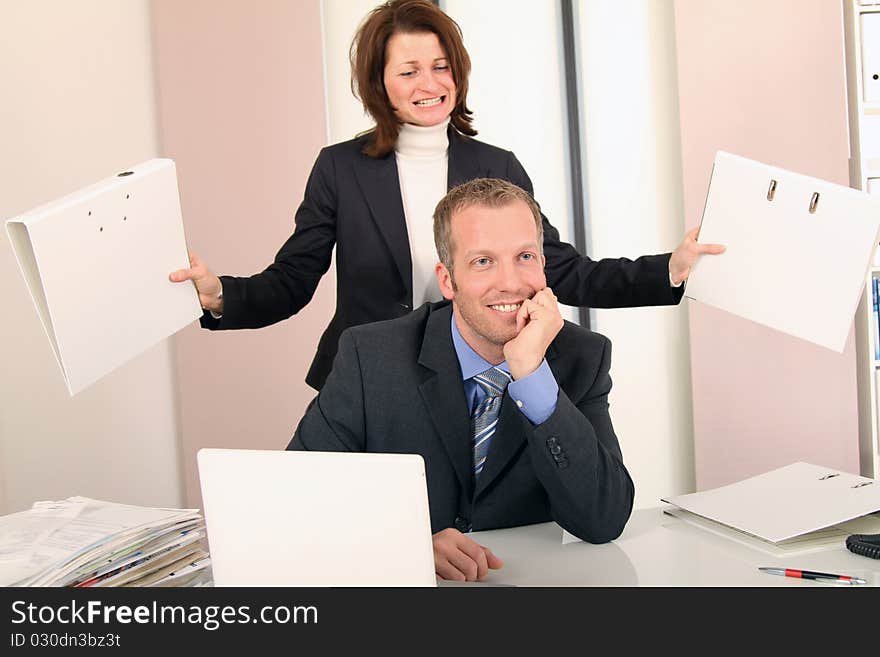 Typical office scene between man and woman. Typical office scene between man and woman