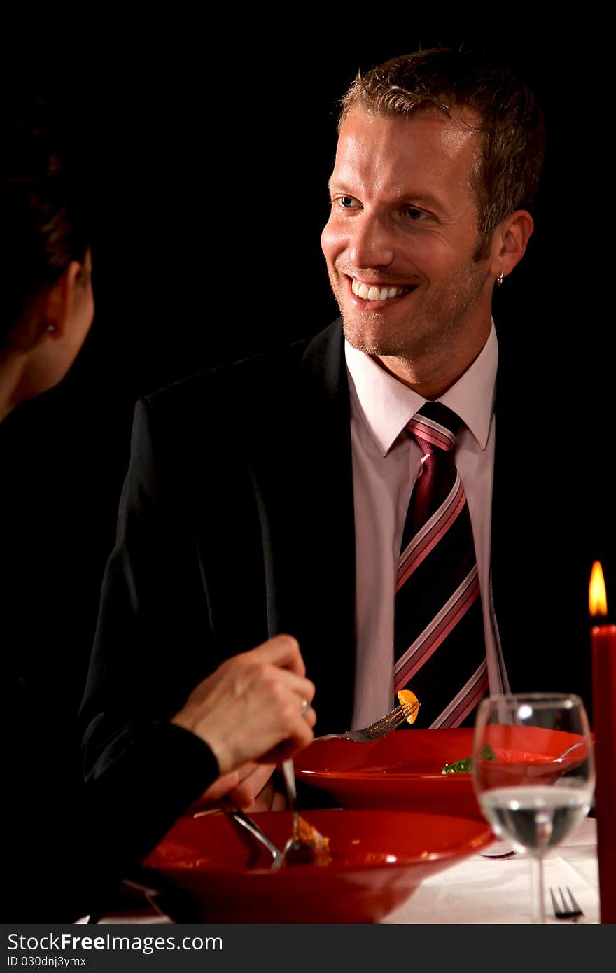 Man and woman having a romantic candle light dinner