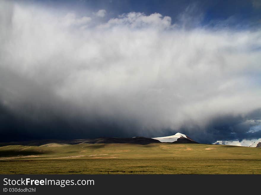 Beautiful white towering cumulus thunderstorm clouds in tibet land