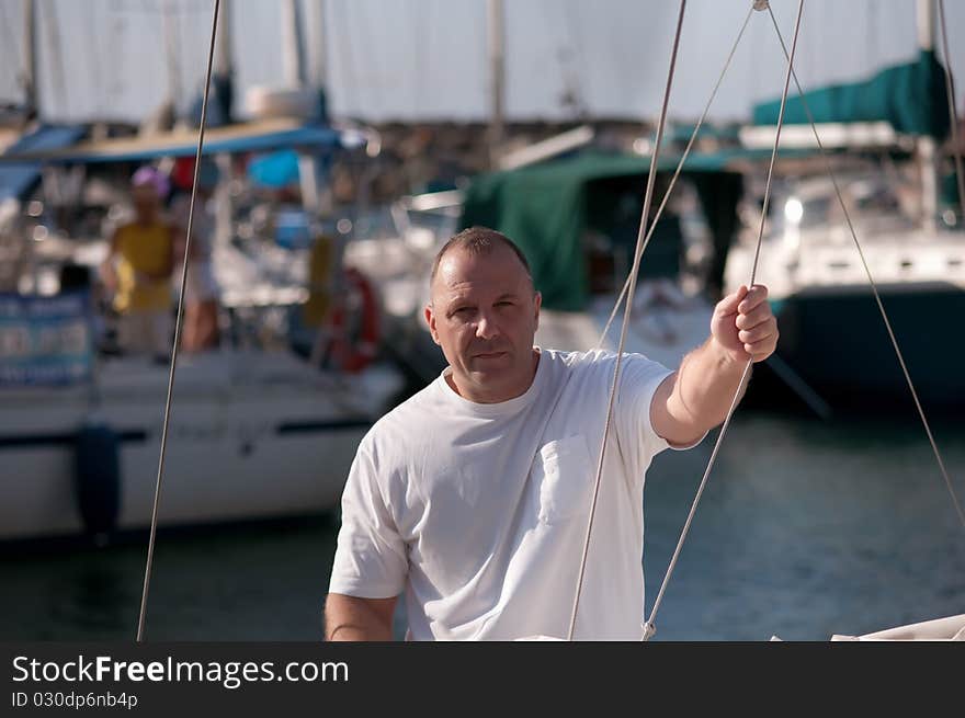 Handsome man on a yacht boat in summer . Handsome man on a yacht boat in summer .