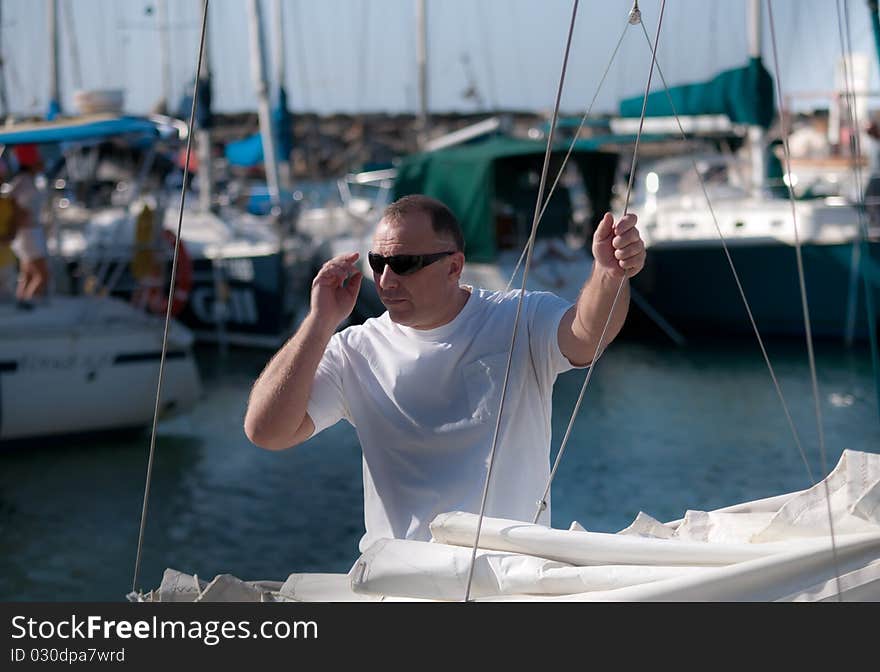 Handsome man on a yacht boat in summer . Handsome man on a yacht boat in summer .