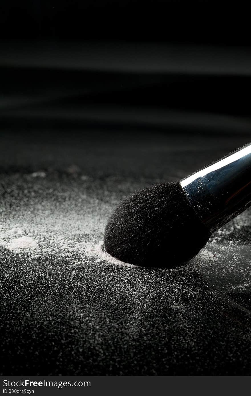 Detail of a powder brush with white loose powder