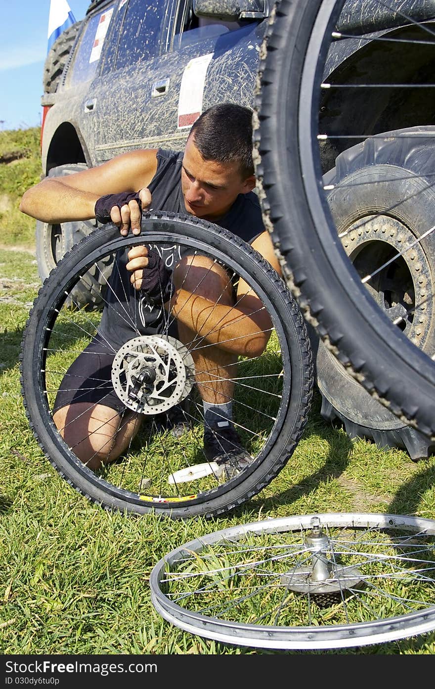 The Bicyclist broken repairs wheel. The Bicyclist broken repairs wheel