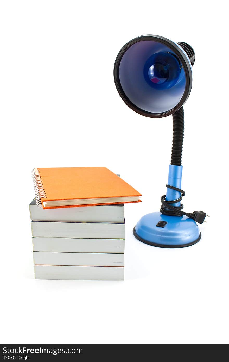 Desk lamp and book heap isolated on white background. Desk lamp and book heap isolated on white background