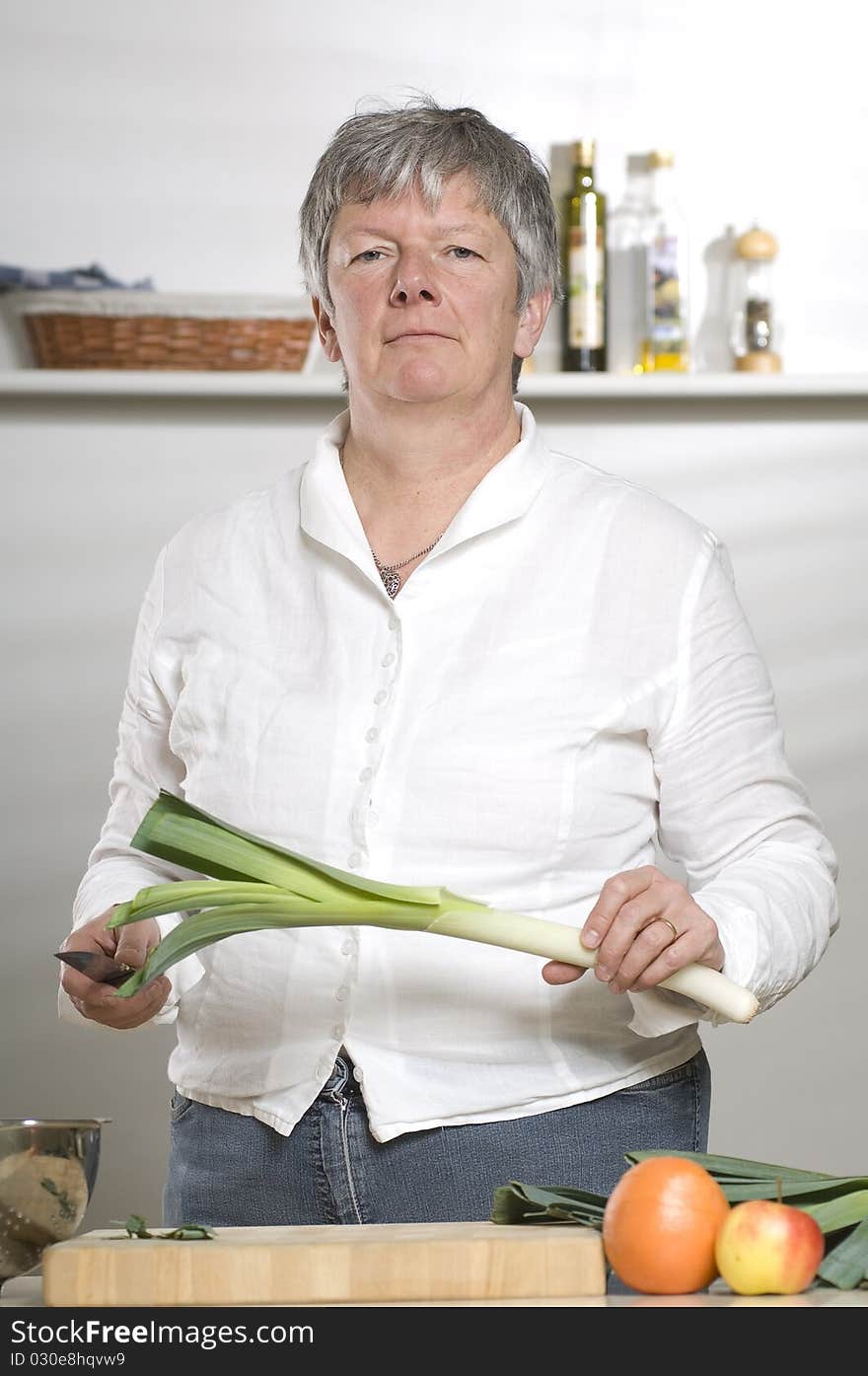 Women Is Cutting Leek