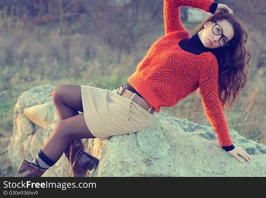 Girl on a rock, fashion woman. Girl on a rock, fashion woman