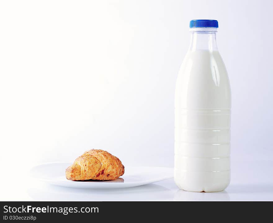 Croissants and milk on white background