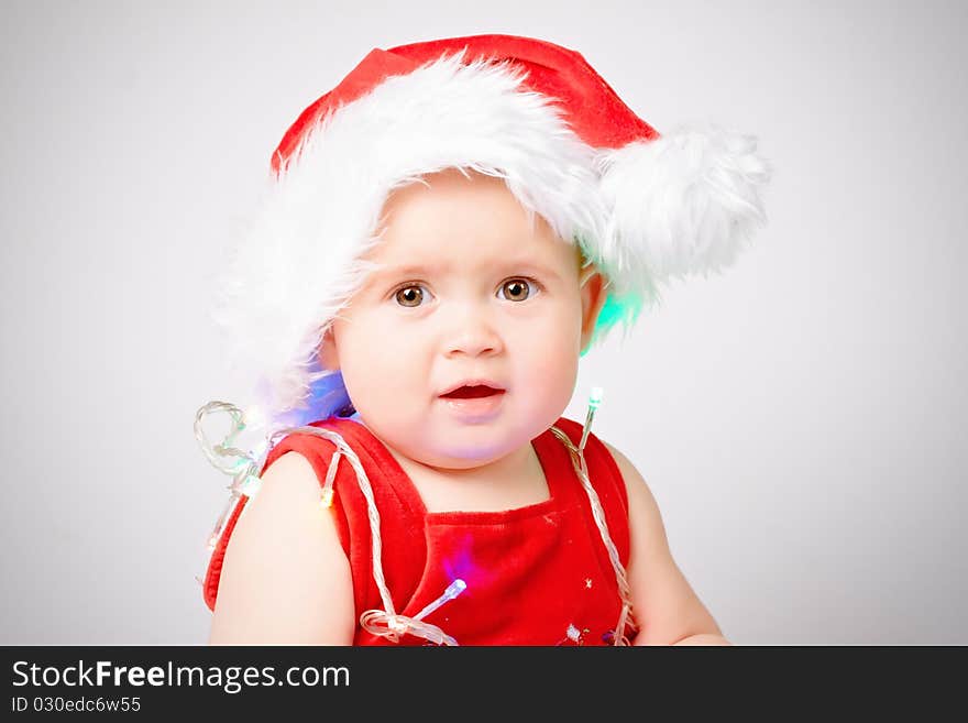 Baby in Santa Claus hat on white background