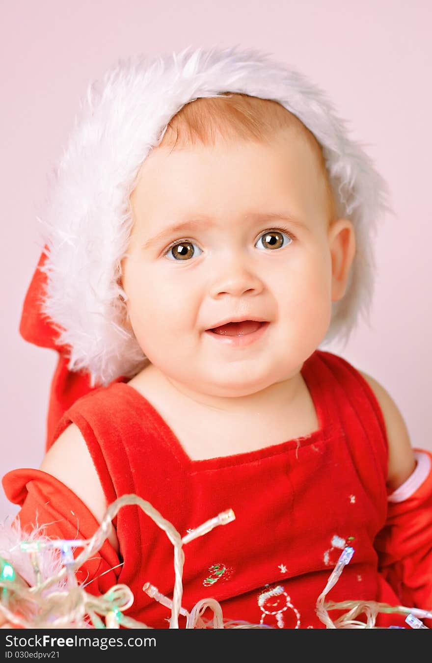 Baby in Santa Claus hat on white background