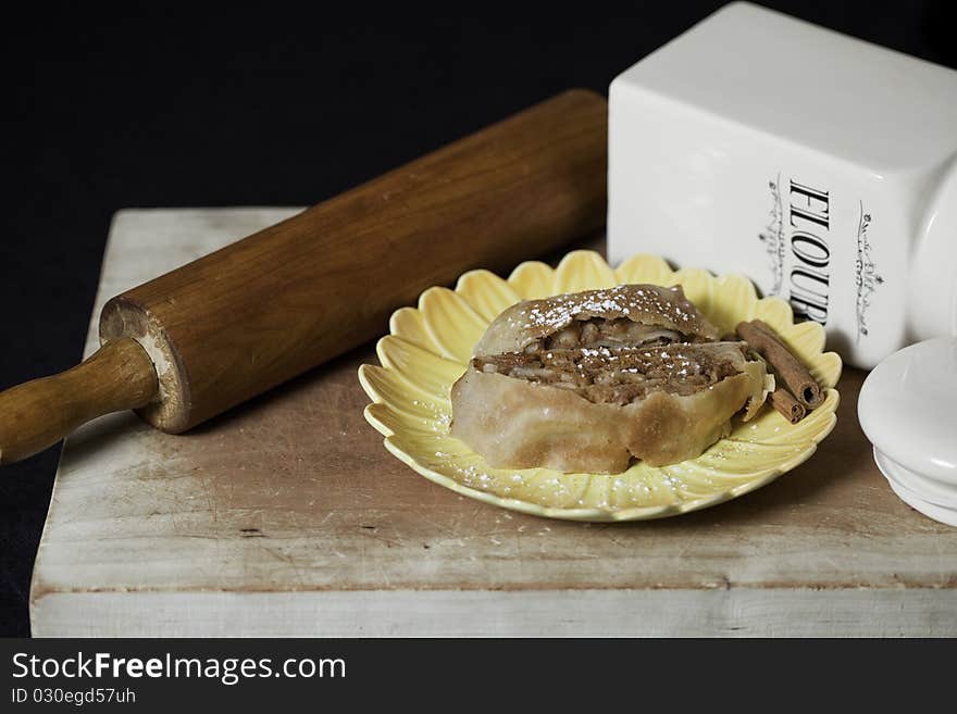 Apple Strudel on plate with powdered cinnamon and powered sugar.