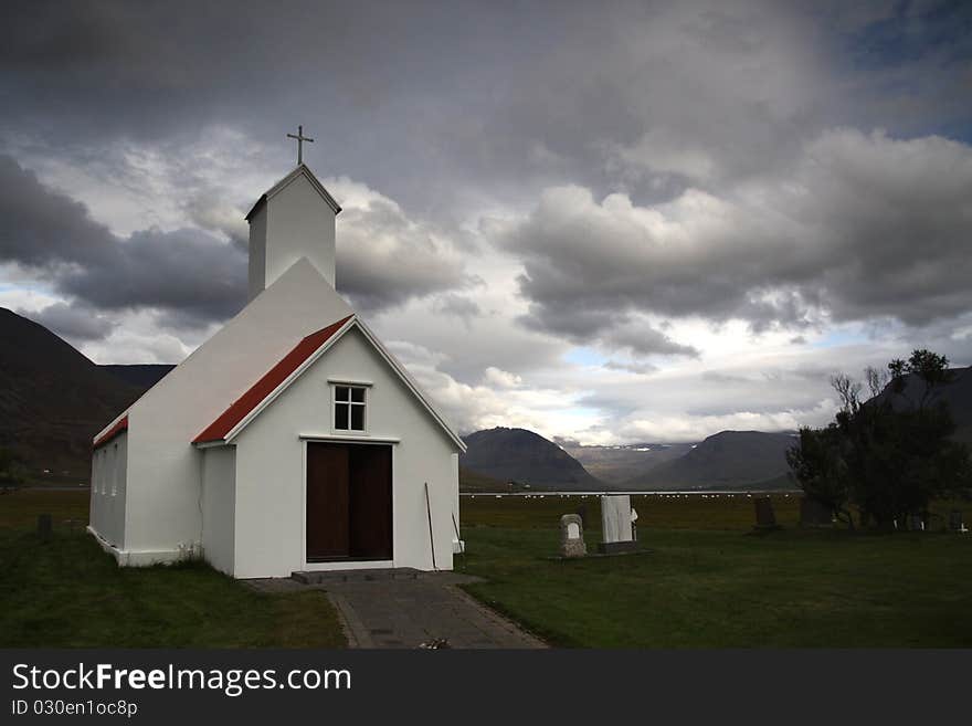 Typical Icelandic Wooden Church with grey clouds