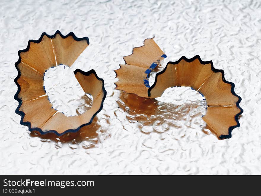 Pencil shavings on the bottom of corrugated metal