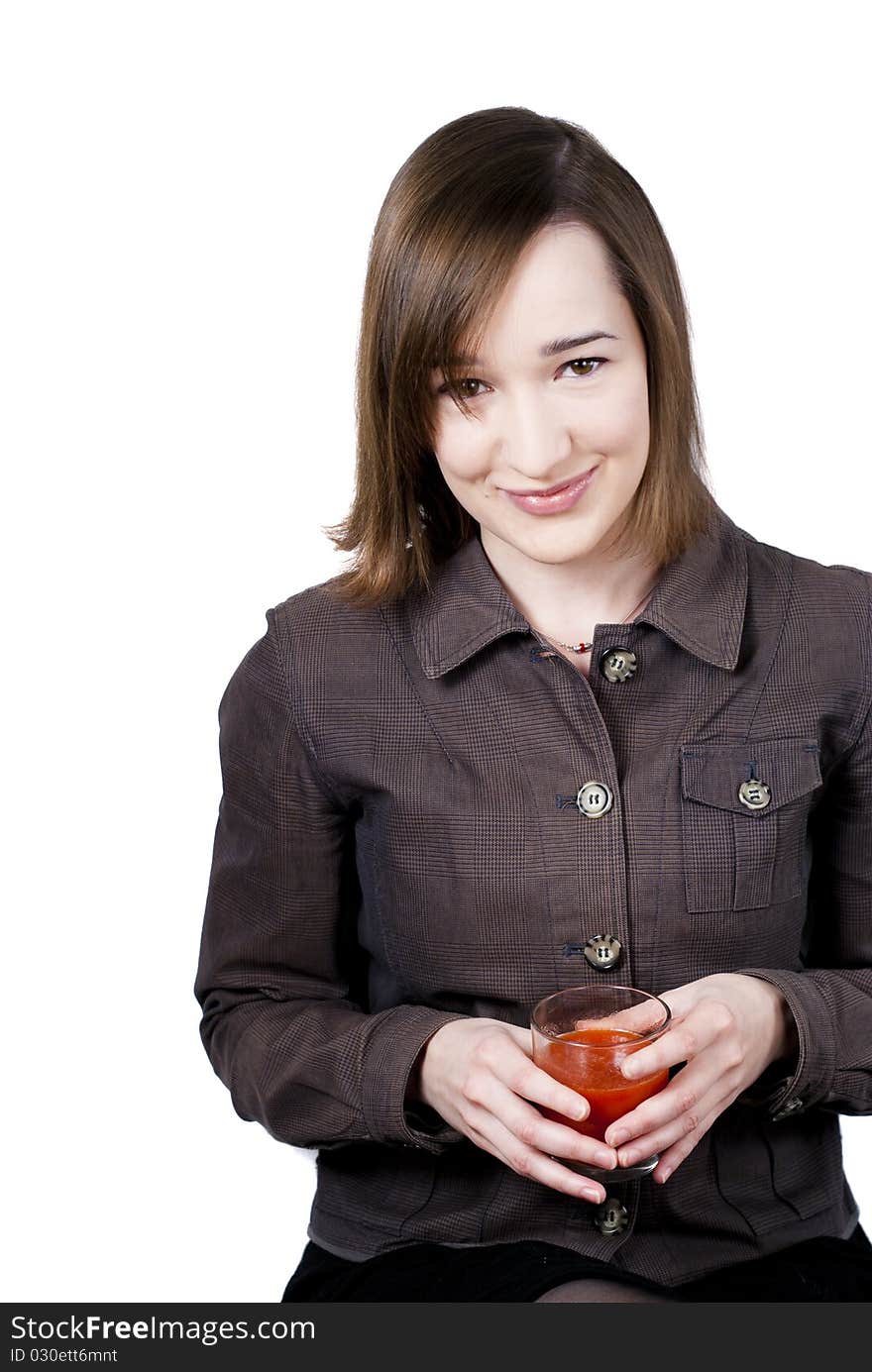 Smiling girl holding the glass of tomato juice isolated