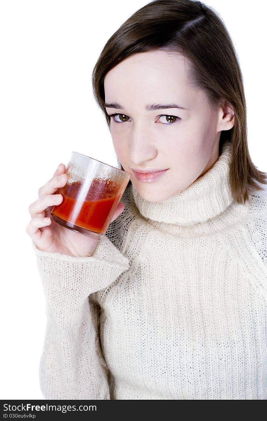 Girl drinking the glass of tomato juice isolated