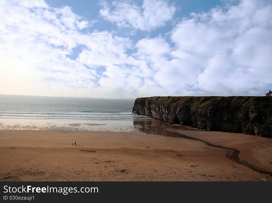 A view of the beach cliffs in ballybunion co kerry ireland with walkers. A view of the beach cliffs in ballybunion co kerry ireland with walkers