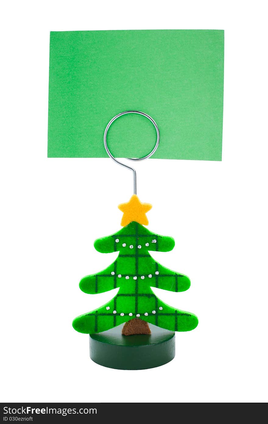 Green note paper in Christmas tree sticker holder on a white background