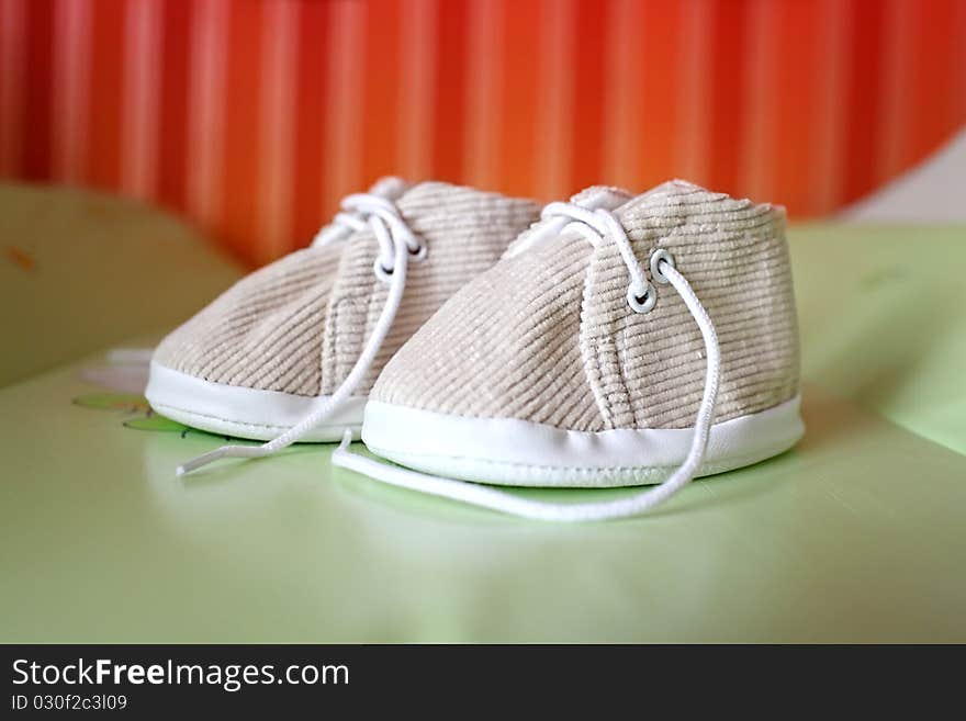 Baby shoes on a colored background