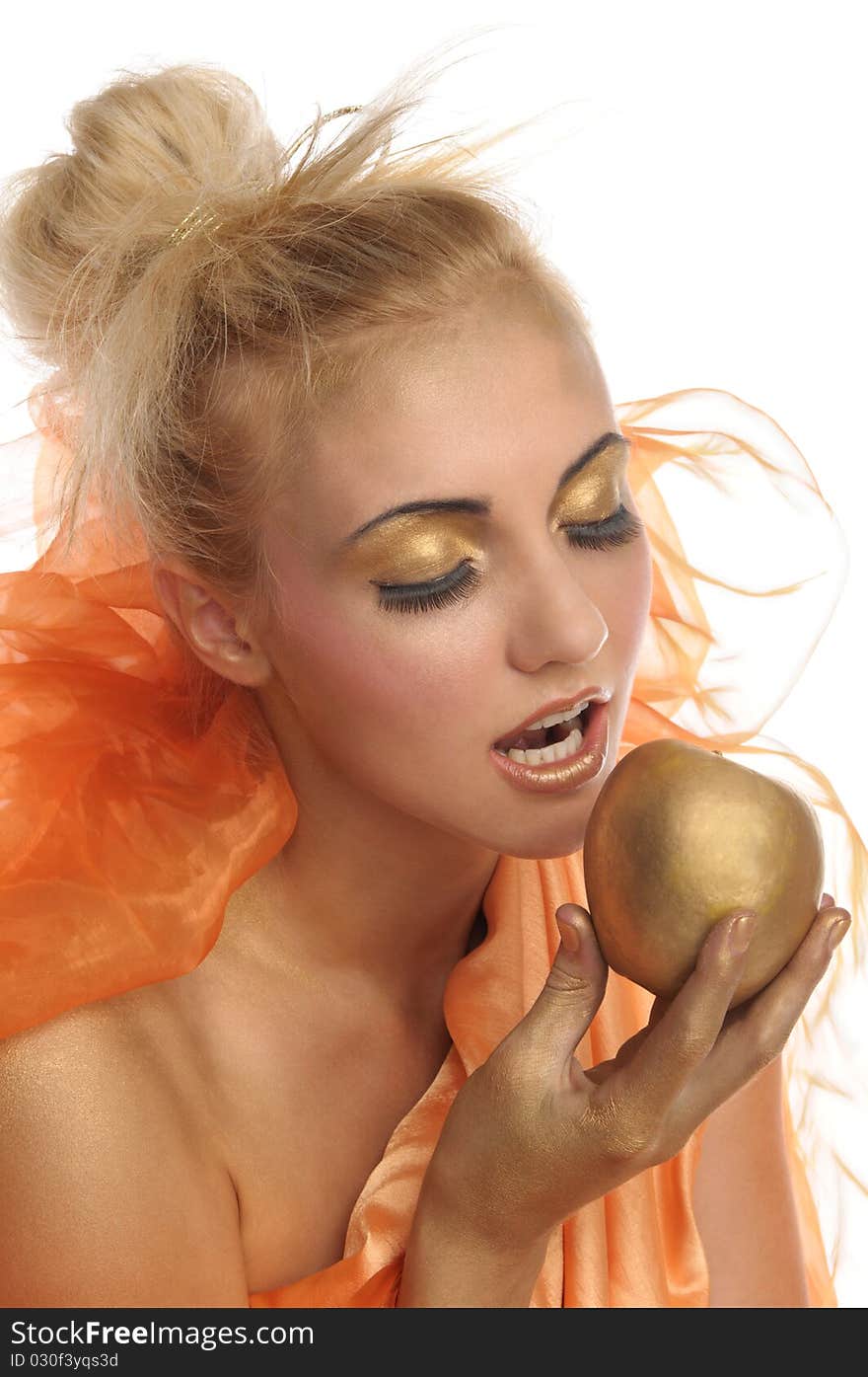 Beautiful woman in gold with apple