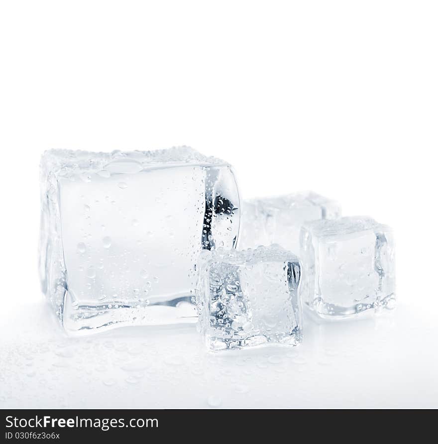 Melting ice cubes over white closeup shallow dof