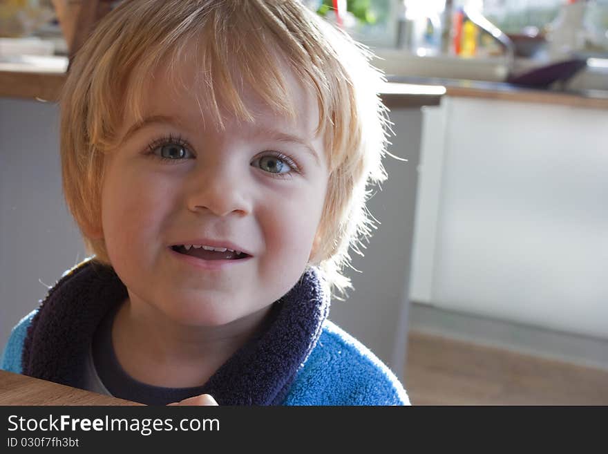 Close up of little boy smiling in the kitchen. Close up of little boy smiling in the kitchen