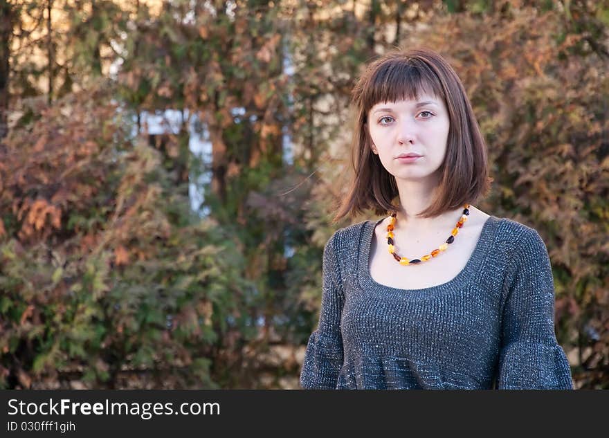 Portrait of a girl on a background of autumn leaves