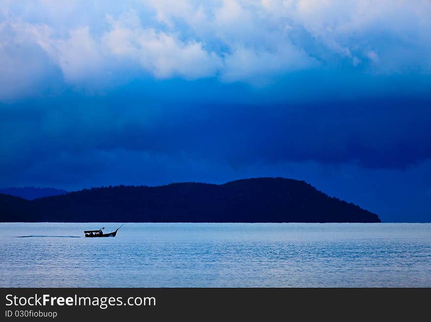 Thunder storm with rain lit by the sun at a lake