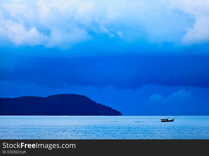 Thunder storm with rain lit by the sun at a lake