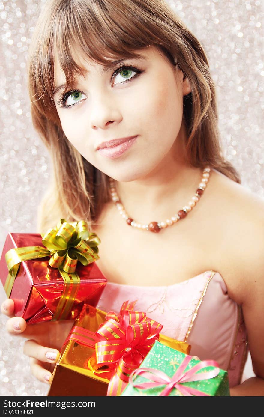 Dreamy beautiful girl holds the holiday gifts