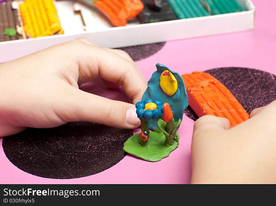 Children's hands make a plasticine