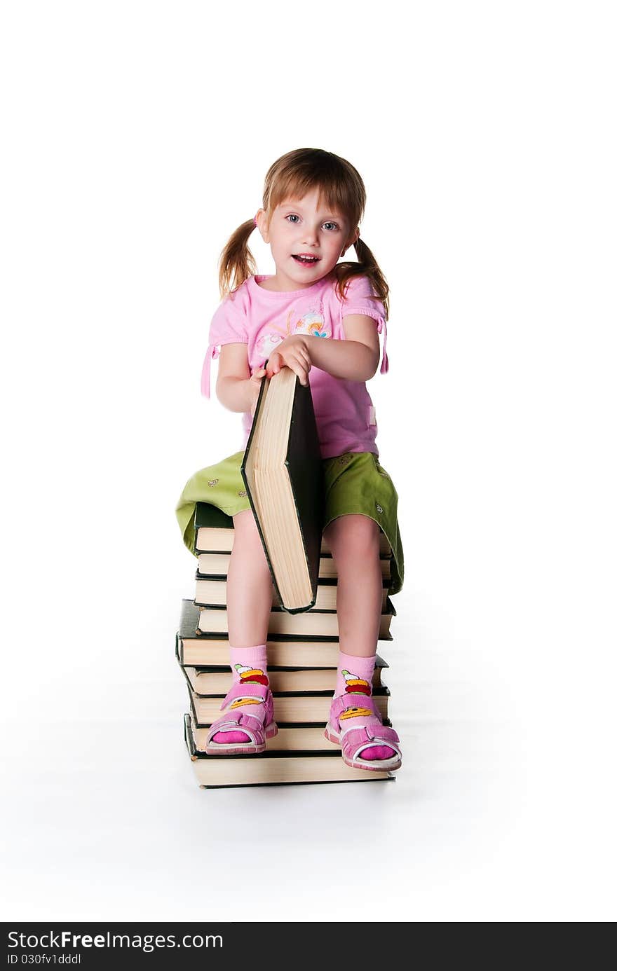 Cute little girl sit on a stack of big books on white background. Cute little girl sit on a stack of big books on white background