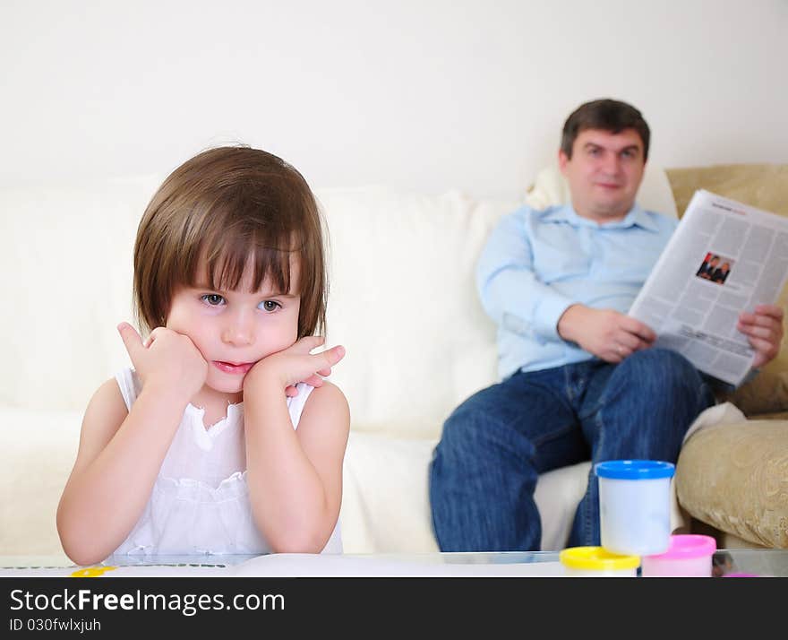 A little girl alone draws on the album.