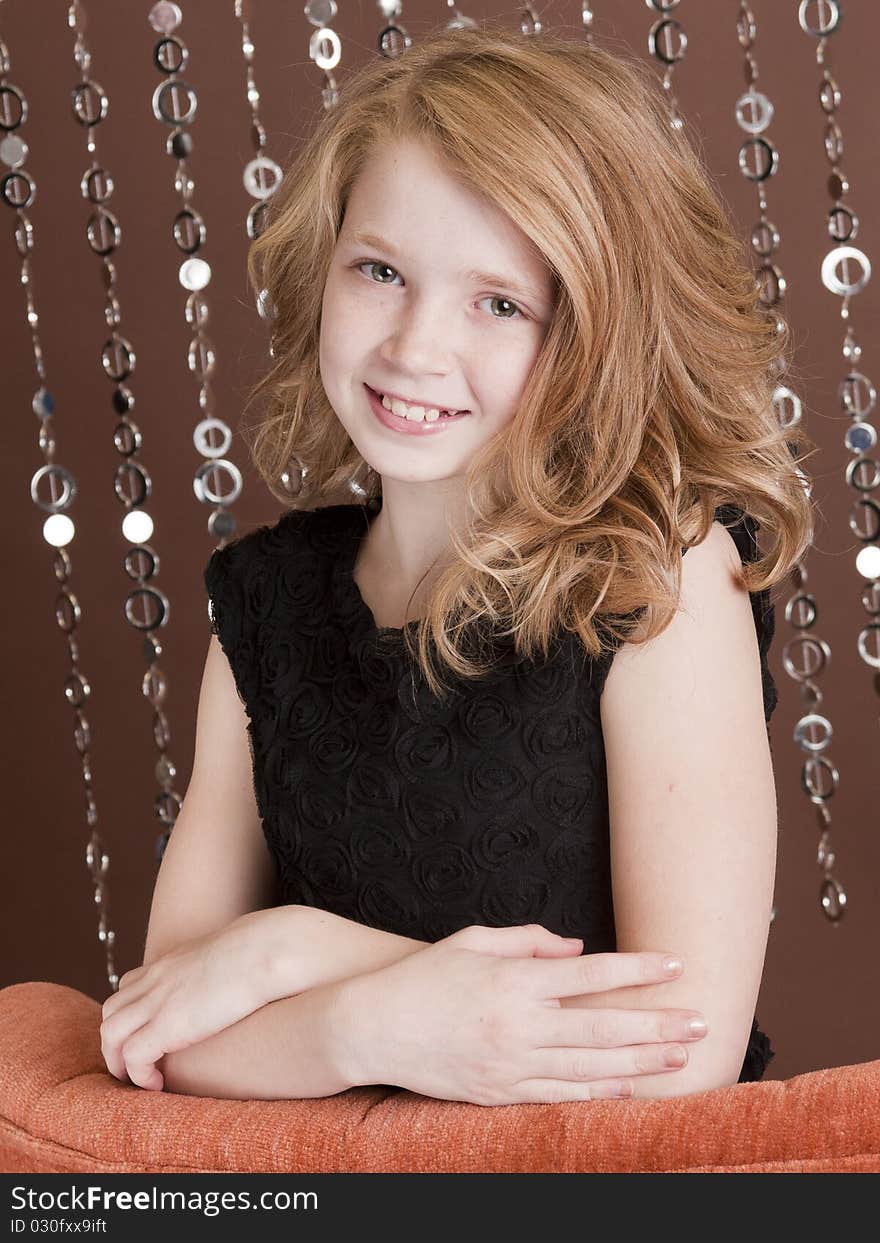 Beautiful young girl posing for the camera in her holiday dress. Beautiful young girl posing for the camera in her holiday dress