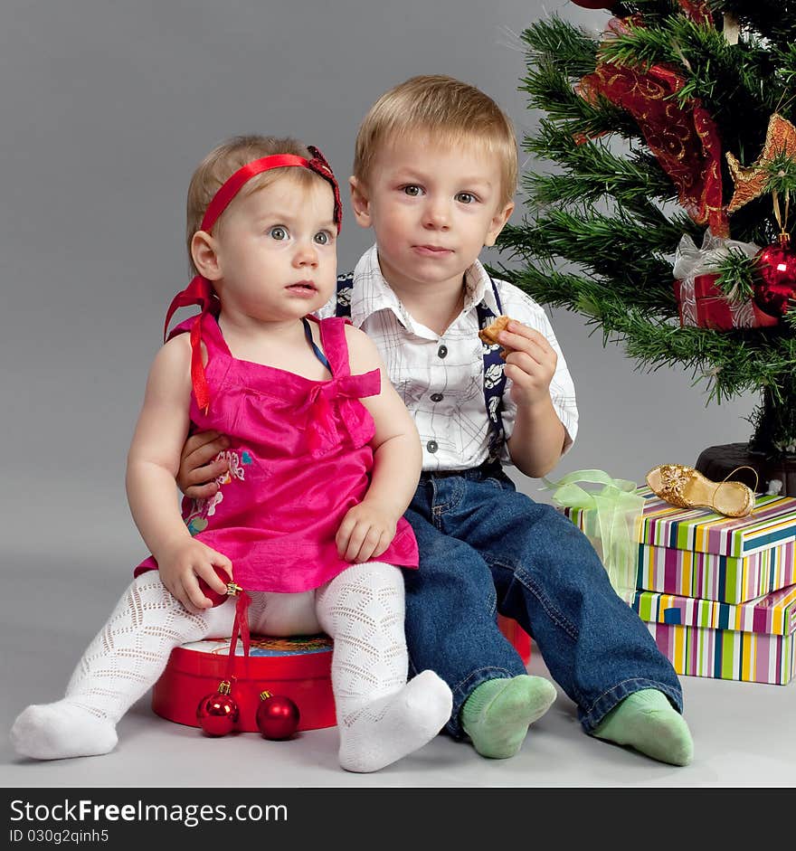 Brother and sister with their presents at christmas time